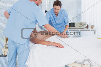 Medical team resuscitating a man with a defibrillator