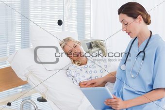 Doctor showing tablet to her patient