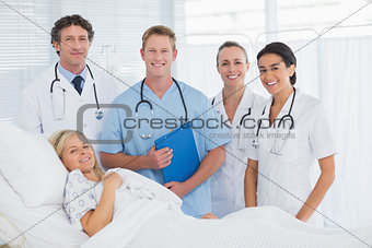 Team of doctor and patient looking at camera