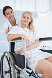 Doctor and patient in wheelchair smiling at camera