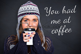 Composite image of beautiful woman in warm clothing drinking coffee