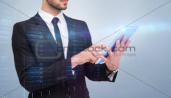 Composite image of mid section of a businessman using digital tablet pc