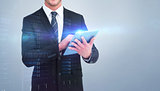 Composite image of happy businessman using his tablet pc