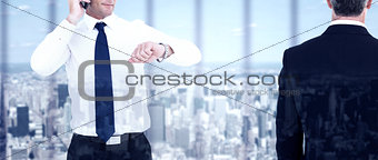 Composite image of rear view of an elegant businessman