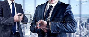 Composite image of focused businessman texting on his mobile phone
