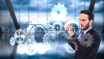 Composite image of focused businessman pointing in suit jacket
