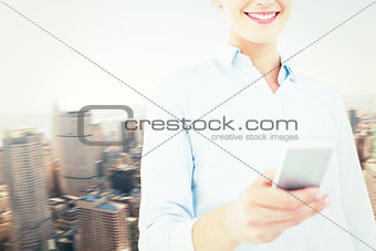 Composite image of businesswoman using her mobile phone