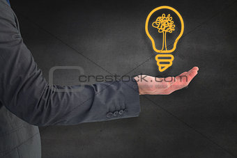 Composite image of businessman holding his hand out