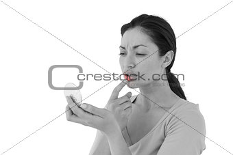 Worried woman looking at her lips