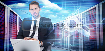 Composite image of cheerful businessman with laptop using smartphone