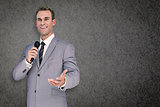 Composite image of businessman giving speech