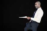 Composite image of businessman with document