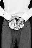 Composite image of businessman in handcuffs holding bribe
