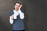 Composite image of woman with headache holding mug