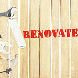 Renovate  against tools on wooden background