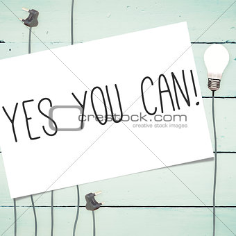 Yes you can! against light bulbs on wooden background