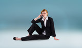 Composite image of redhead businesswoman on the phone