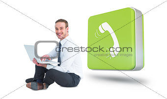 Composite image of happy businessman sitting and using laptop