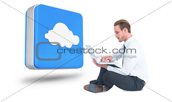 Composite image of smiling businessman sitting on floor using laptop