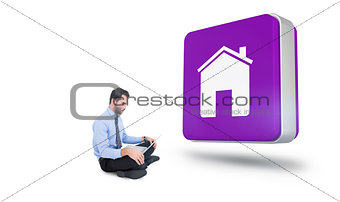 Composite image of cheerful businessman sitting on the floor using laptop
