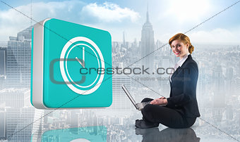 Composite image of redhead businesswoman using her laptop