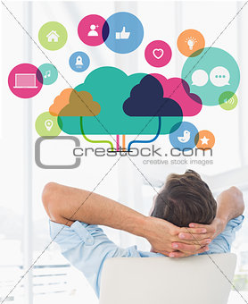 Composite image of rear view of a casual man resting with hands behind head in office