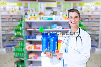 Composite image of happy doctor holding tablet pc