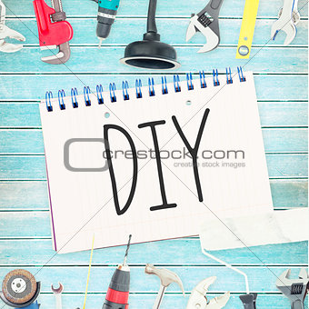 Diy against tools and notepad on wooden background