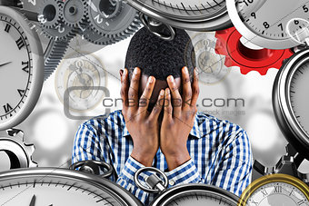 Composite image of young businessman with head in hands