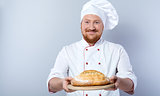 Head-cook holding freshly baked bread