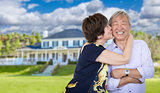 Affectionate Senior Chinese Couple In Front of Beautiful House