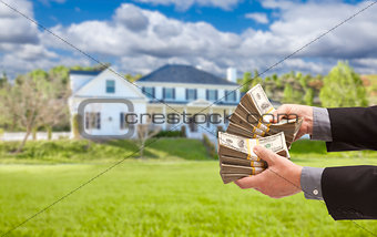 Man Handing Over Hundreds of Dollars in Front of House