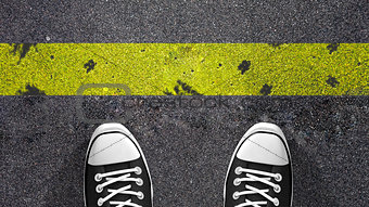 Cross the yellow line ? Concept illustration showing shoes in front of a yellow line.