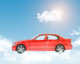 Blue sky with clouds and red car
