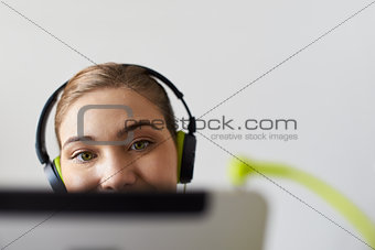 Woman With Green Earphones Listens Podcast Music On Tablet PC
