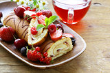 biscuit roulade with butter cream and fresh berries