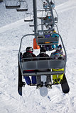Snowboarders on chair-lift