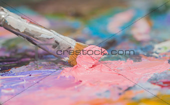 pink paint brushes and oil paints