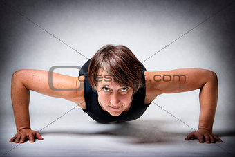 Middle aged woman doing push-ups
