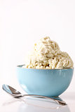 Bowl of vanilla ice cream on table