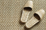 Seagrass spa slippers on woven carpet
