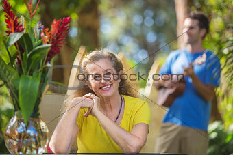 Grinning Woman Listening to Musician