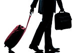 business traveler man walking with handbag and  suitcase silhoue