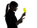 business woman showing yellow card silhouette