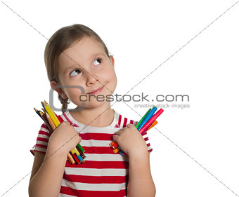 cute little girl holding colourful pencils and markers looking u