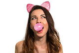 Cute playful girl blowing pink chewing bubble gum looking up on 