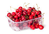 Sweet cherries in plastic tray and three near top view