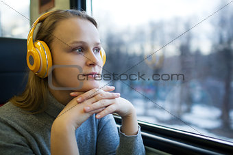 Woman traveling by train with favorite music