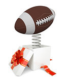 Gift box with red band and rugby ball on spring