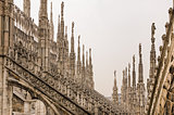 Detail view of stone sculptures on roofs of Duomo Milano